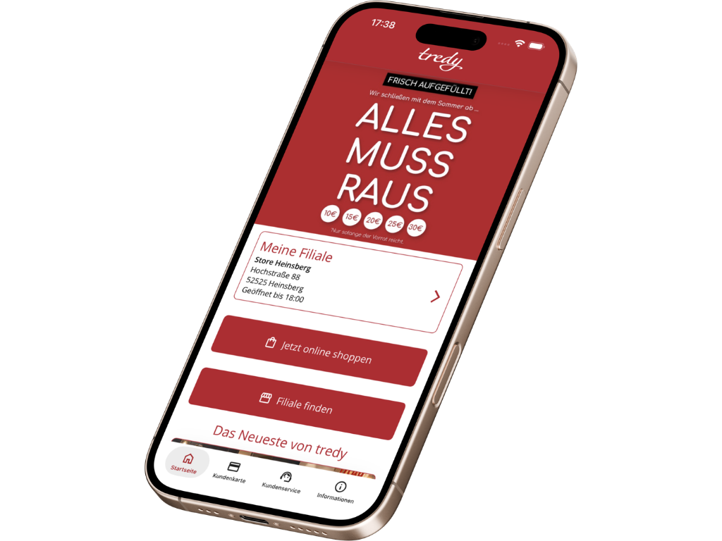 Smartphone-Mockup der tredy Shopping App mit Aktionsbanner „ALLES MUSS RAUS", Filialinformation Heinsberg (geöffnet bis 19:30) und CTAs „Jetzt online shoppen" und „Filiale finden".